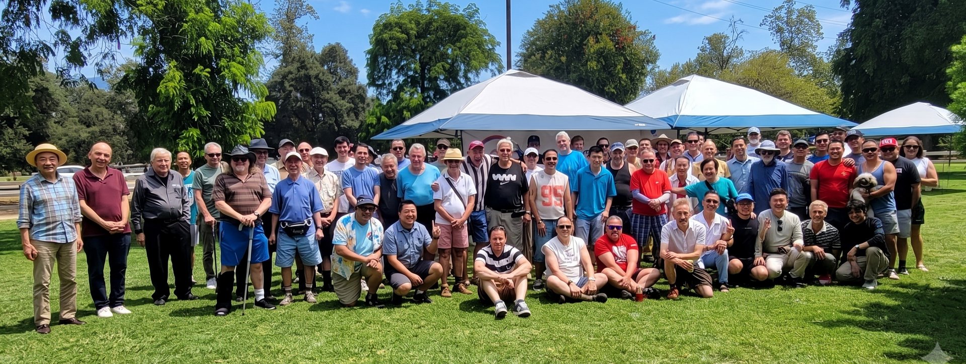 About sixty A/PGF members and friends gathered on the grass for a group photo at the 2026 4th of July Picnic